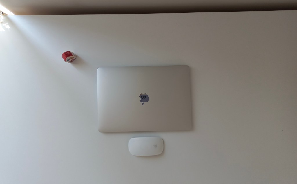 A desk with laptop on it